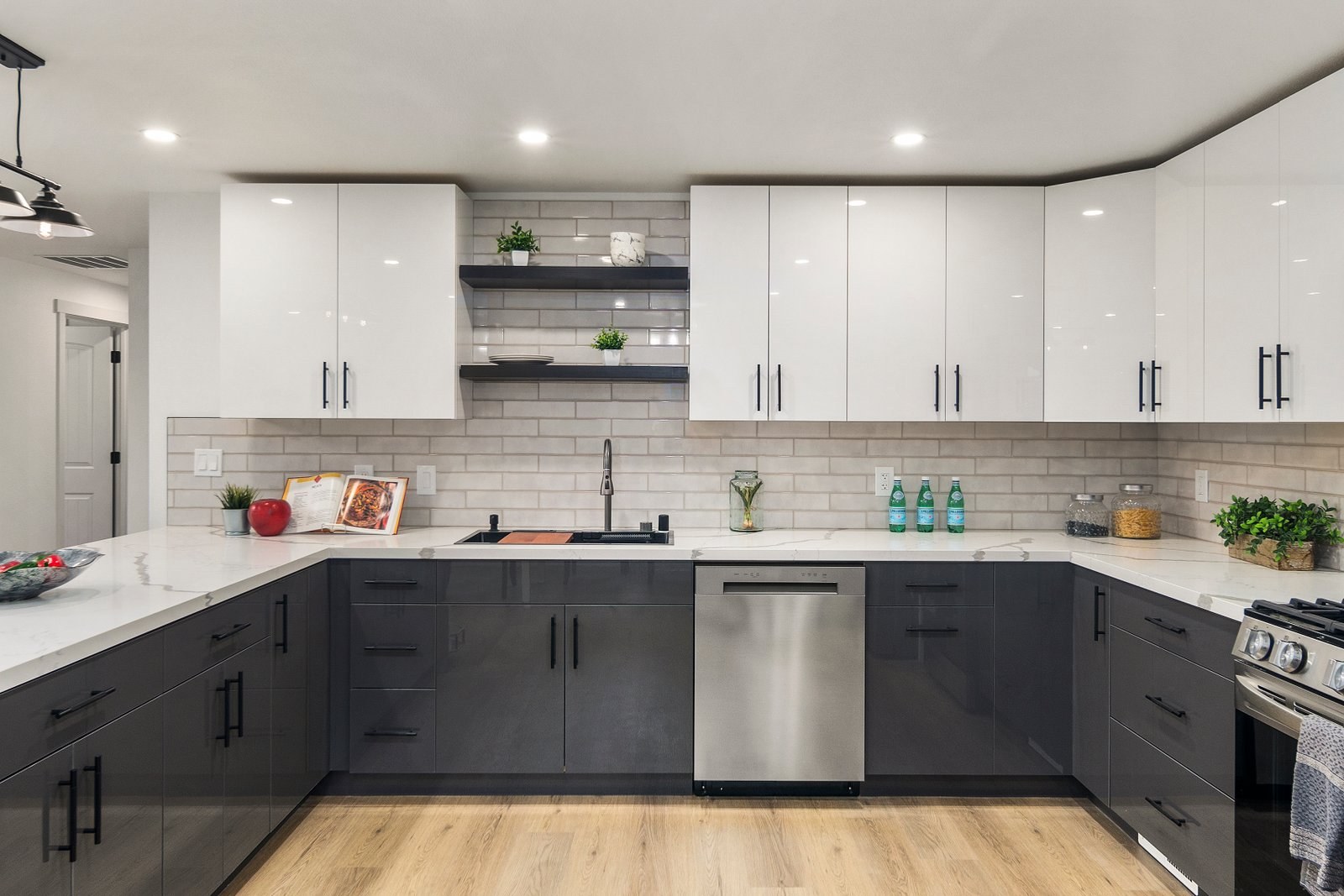 Remodeled kitchen with grey lower cabinets and white uppers