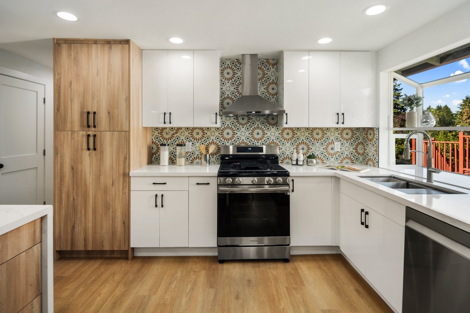 Kitchen with wood cabinetry and patterned tile backsplash
