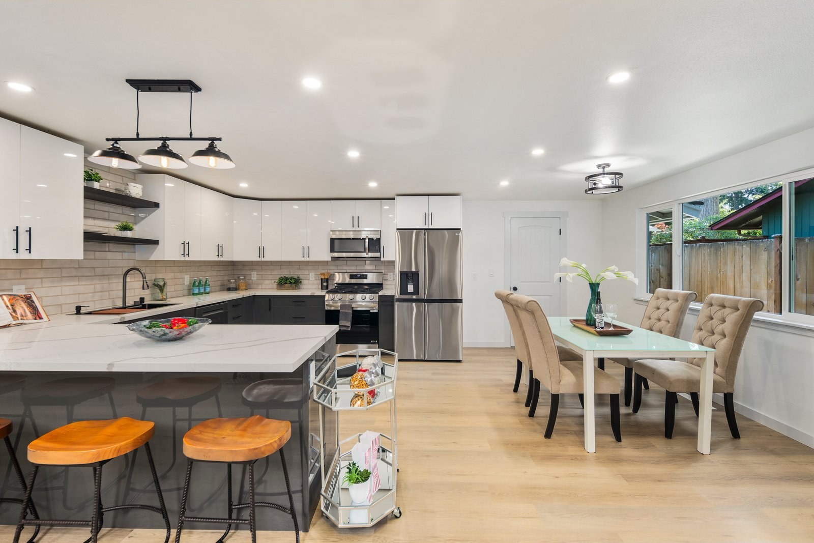 Kitchen with large island, bar stools and open dining area